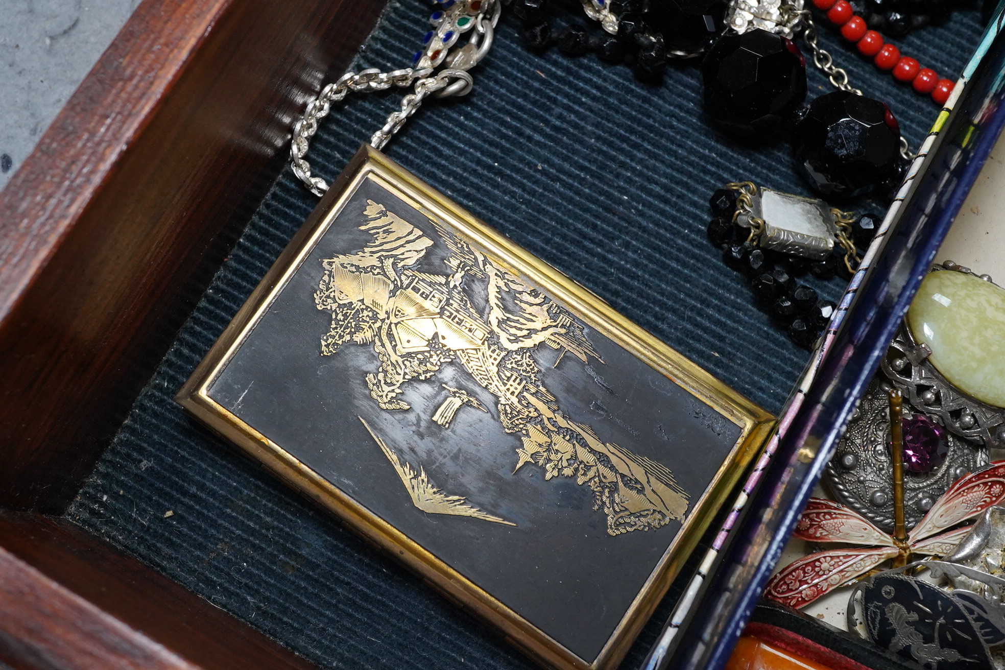 A group of assorted costume jewellery including an amber cigar holder and a Burberry gilt metal spaniel brooch